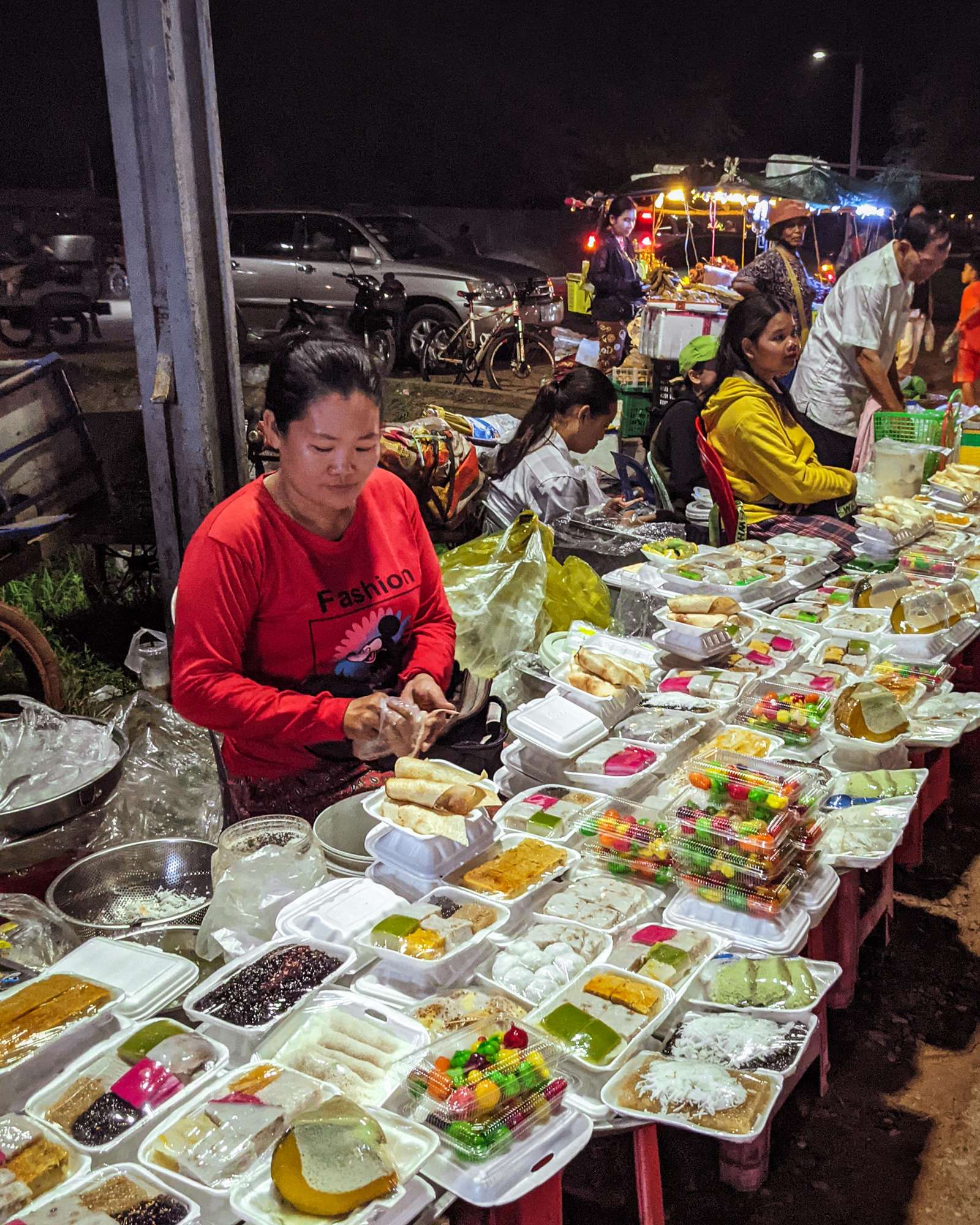 Women selling Cambodian desserts at a night market in Siem Reap