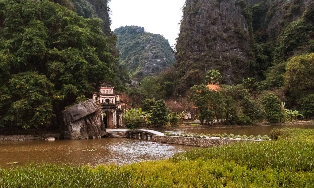 Entrance of Bich Dong Pagoda across a river