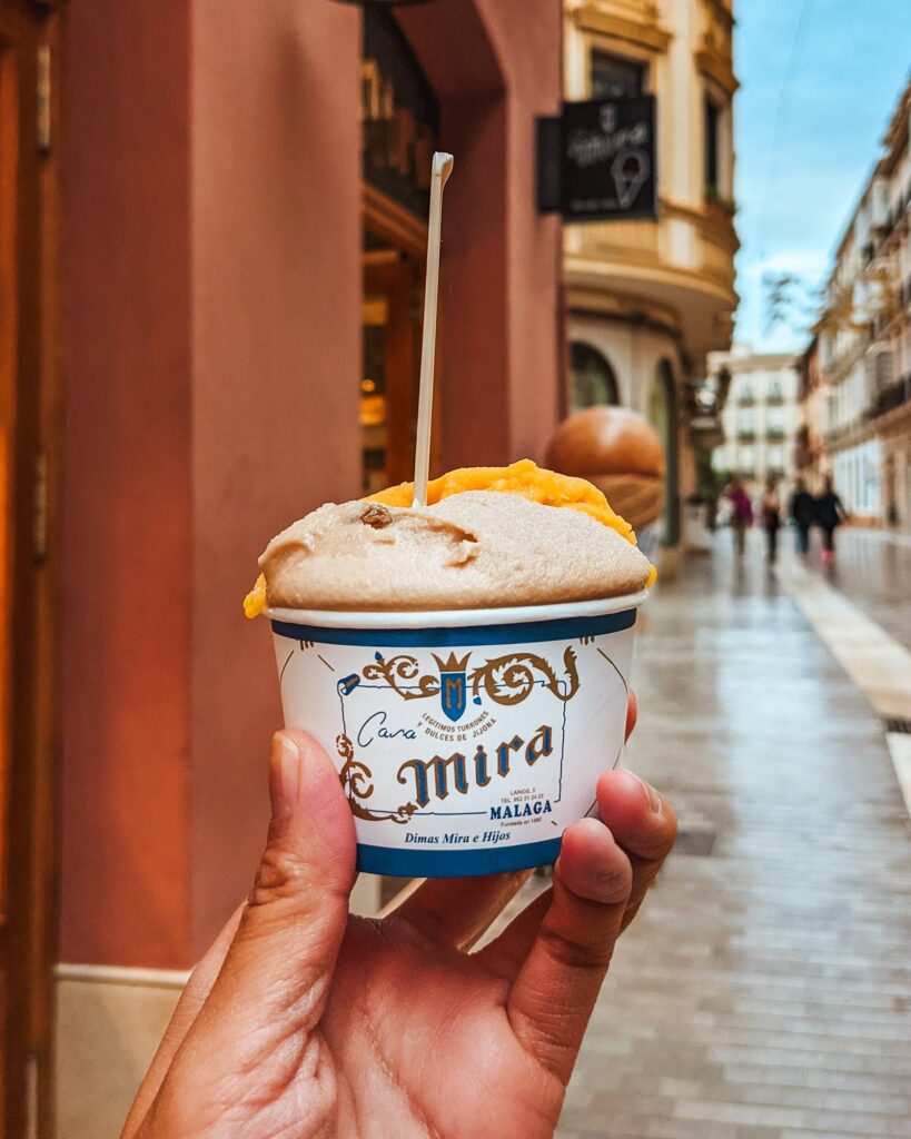 Hand holding a cup of ice cream from Casa Mira in Malaga