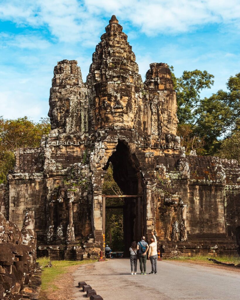 Tourists standing outside the entrance to Bayon Temple in Angkor Wat